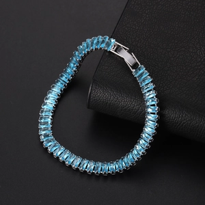 Macro view of sky blue rectangular cut zircon bracelet with silver metal clasp detail