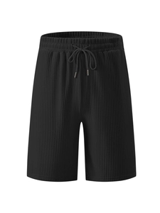 Detail view of black corduroy shorts featuring elastic waistband and adjustable drawstring