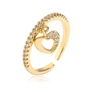 Gold-plated open heart ring with zircon stones shown from a side view on white background
