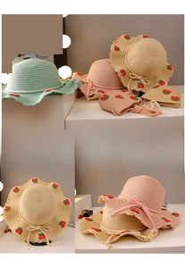 Detail of girls' cherry straw sun hat and matching bag with wave brim and ribbon