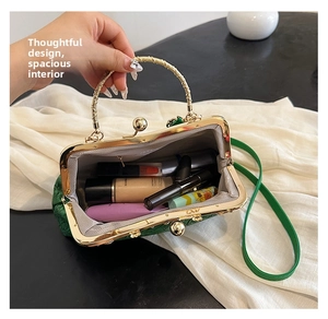 Detailed interior of green embossed shell bag showing spacious makeup storage