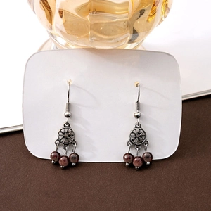 Vintage bohemian silver earrings with circular hollow design and red garnet beads