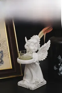 Detailed view of European white angel resin candle holder with a clear glass cup