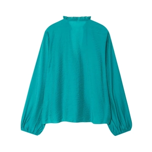 Detail of teal satin shirt featuring elastic cuffs and elegant pleated stand collar