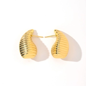 Close-up of 14K gold plated earrings featuring a polished ribbed texture and curved teardrop shape