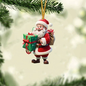 Close-up of Santa Claus acrylic ornament hanging on a Christmas tree with a gold string
