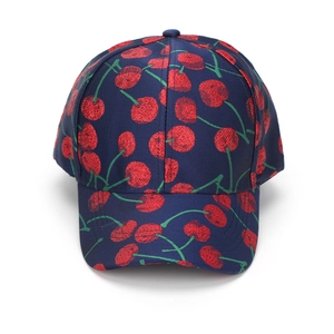 Detailed close-up of navy blue baseball cap with red cherry jacquard pattern