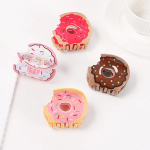 Set of four cute donut-shaped hair claws in red, brown, white, and pink acrylic material