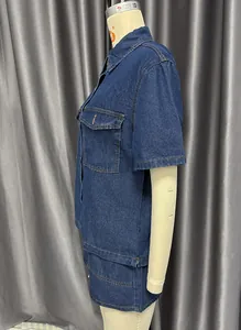 Detail of dark blue denim set with vintage loose fit shirt and shorts with orange stitching