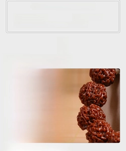 Close-up of dark red-brown Rudraksha seeds with deep texture and oily jade-like finish