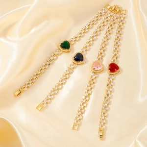 Luxury gold heart bracelets with colorful gems and white zircons on champagne silk