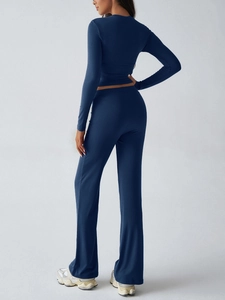 Rear view of tight-fit navy blue long-sleeve T-shirt and yoga pants athletic set