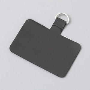 Close-up of a durable black TPU phone tether tab with a silver D-ring connector