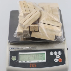Macro shot of a bulk pack of 10 wooden base photo clips on an electronic weight scale