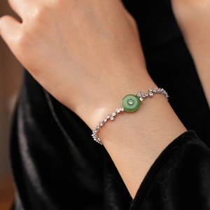 Close-up of a green chalcedony bracelet with zircon accents on a model wrist