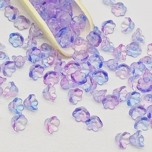 Macro detail of lily of the valley glass beads with purple and blue gradient petals