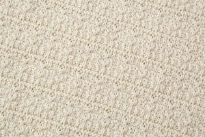 Gros plan sur la texture du tricot blanc crème montrant les détails de couture fins
