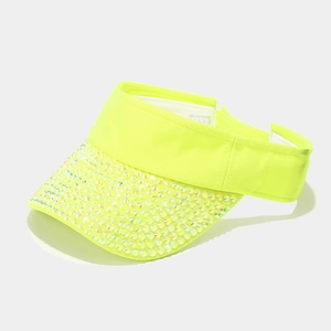 Detail of neon green visor hat showing colorful rhinestones and 100% polyester label