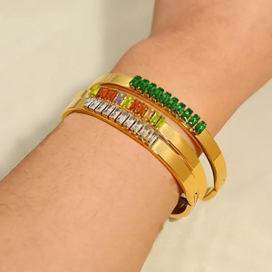 Elegant set of three gold plated bracelets with green and multicolor rectangular crystals