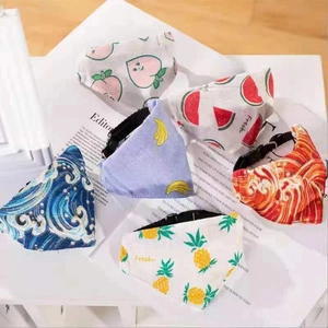 Various fruit pattern dog bandanas with adjustable black buckles on a clean background