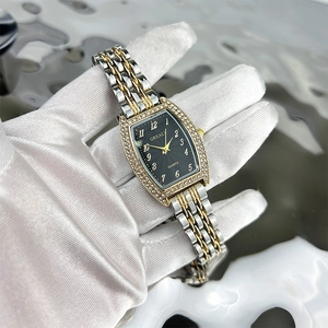 Detailed macro view of Grealy tonneau-shaped emerald quartz watch with diamond-set bezel