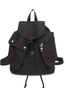Black nylon drawstring backpack with buckle flap and side pockets on white background