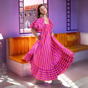 Orange and pink striped puff sleeve dress with a voluminous tiered skirt for beach vacations