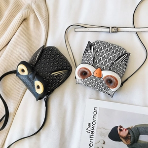 Detailed view of fashion owl shaped crossbody bags in black and printed leather finishes