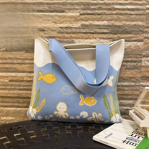 Detail of knitted tote bag showing nautical patterns with octopus and fish motifs