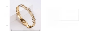 Detail view of gold zigzag bangle with sparkling crystals and 55mm inner diameter