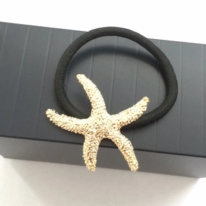 Golden starfish elastic hair tie with textured metal design for a summer ocean style