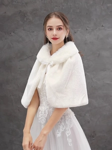 Detail of white faux fur bridal shawl with silk ribbon bow and plush collar texture