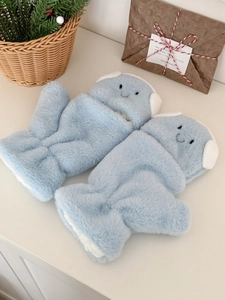 Detail showing plush light blue earmuff gloves with cute smile embroidery and soft texture