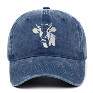 Close-up of a white cow head embroidery on a vintage navy blue washed cotton baseball cap