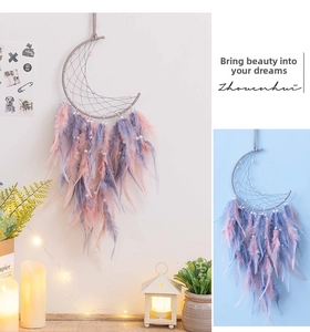 Detail of moon-shaped dream catcher with pink feathers and white pearl accents