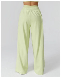 Vue détaillée du pantalon de sport ample vert citron à taille haute et bandes blanches