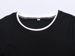 Close-up of the black T-shirt neckline with contrasting white ribbed collar and stitching