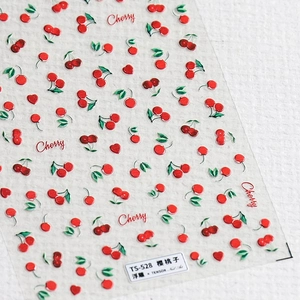 Detailed close-up of TS-528 embossed 5D nail art stickers with cherry and heart motifs
