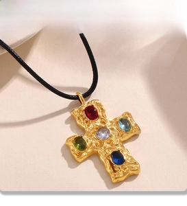 Detail of PVD gold plated cross pendant with multi-colored gemstones and black cord