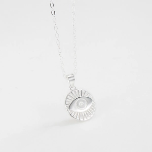 Minimalist 925 sterling silver necklace featuring a round embossed evil eye sunburst pendant