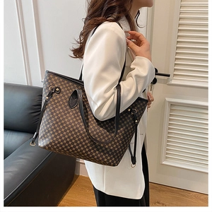 Side view of large geometric print tote bag worn with a white blazer for a chic look