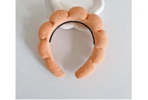 Detail of orange cloud bubble headband with non-slip teeth and soft plush sponge texture