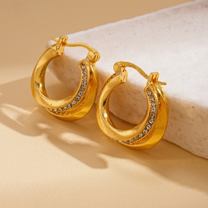 Close-up of double-layered gold hoop earrings featuring sparkling pave-set zircons