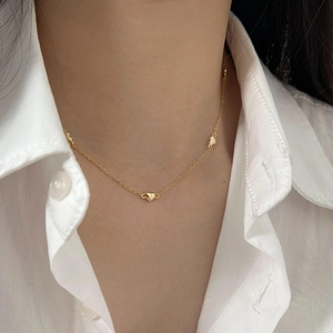 Minimalist 925 silver gold plated heart pendant necklace worn on neck with white shirt