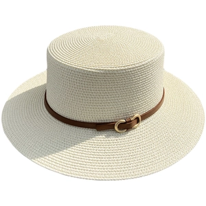 Minimalist cream straw boater hat with flat top and brown leather belt buckle strap