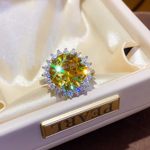 Macro shot of luxury sunflower ring with yellow zircon center in a velvet gift box