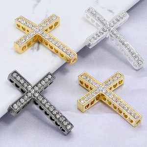 Cross pendants in gold, silver, and gunmetal with crystals and hollow heart side details