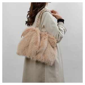 Detail view of plush beige faux fur tote bag with stylish woven shoulder strap