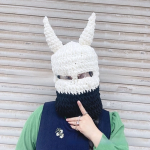 Close-up of handmade thick knit devil horn balaclava with black and white拼接 design
