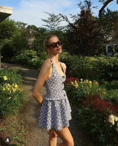 Detail of checkered halter dress featuring backless tie-up bow and ruffled hemline
